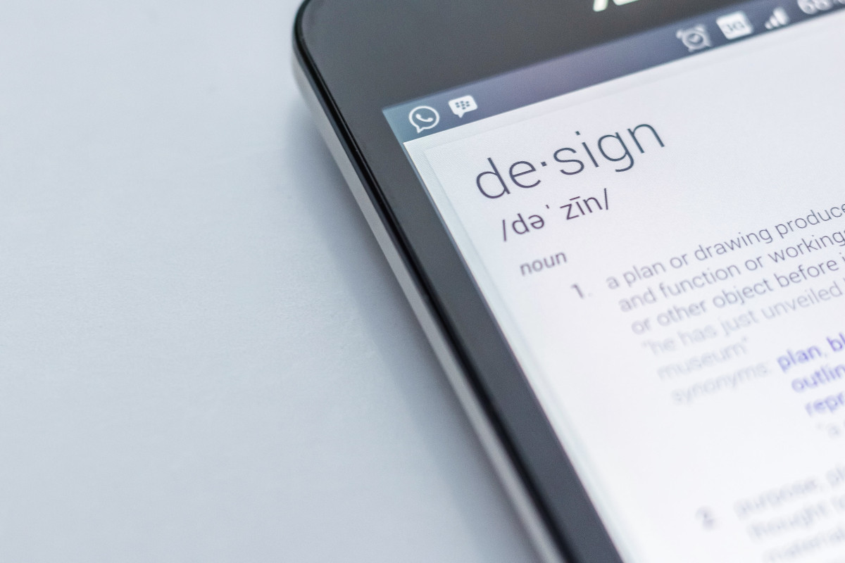 A close up photo black Android smartphone showing the definition of the word &quot;design&quot;.